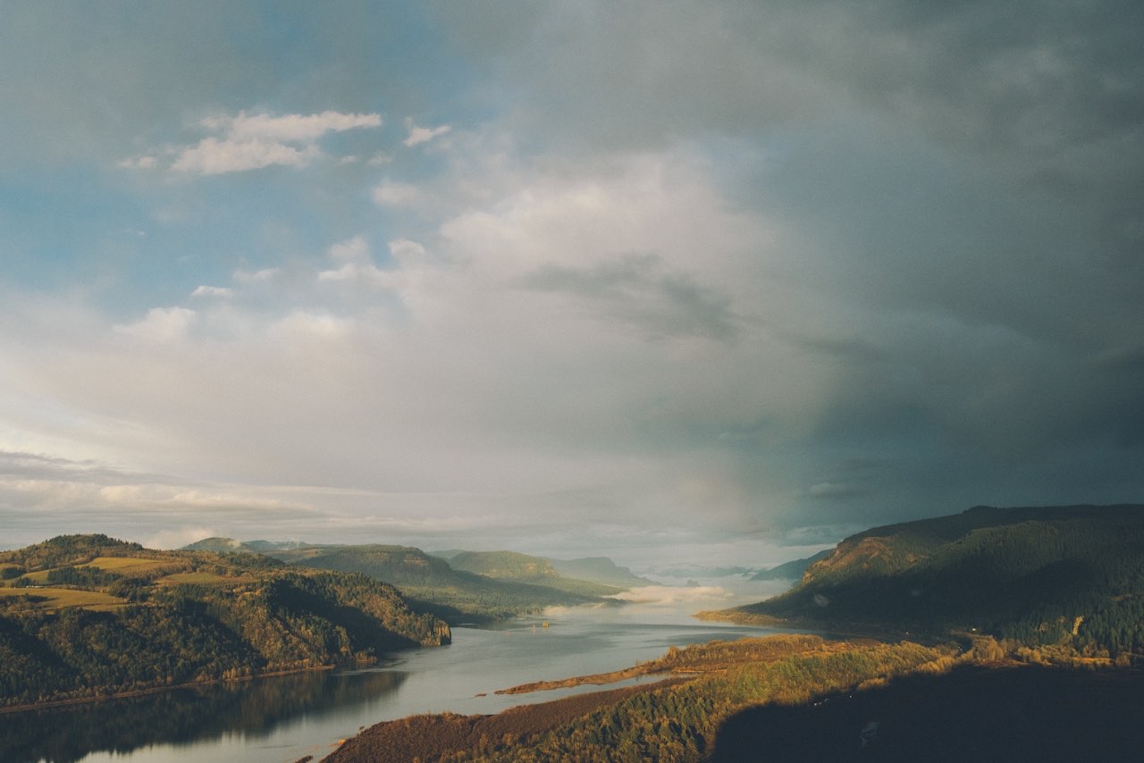wide mountain valley and river under expansive sky